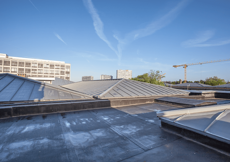 Urban rooftop with crane in distance