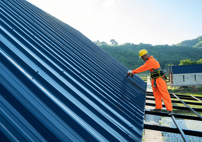 Roofer in safety gear on roof