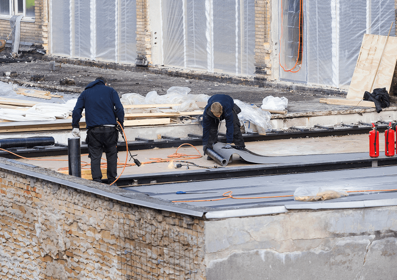 Rooftop renovation with workers and tools
