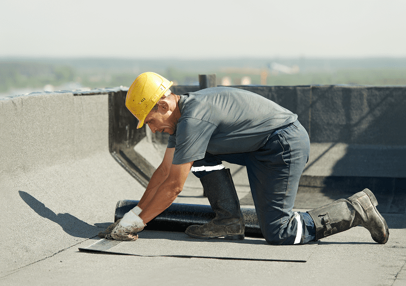 Construction worker on building roof