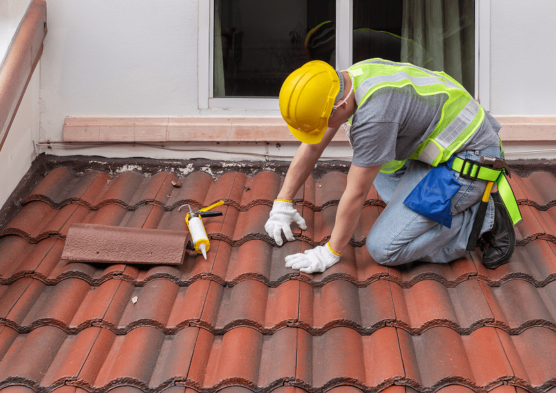 Construction worker on tiled roof