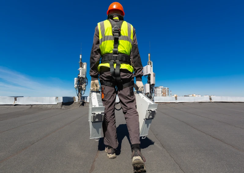 Rooftop maintenance under clear blue sky