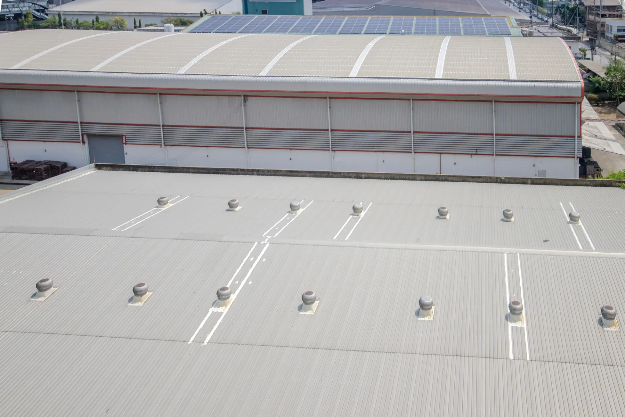 A rooftop with several ventilation units and skylights.