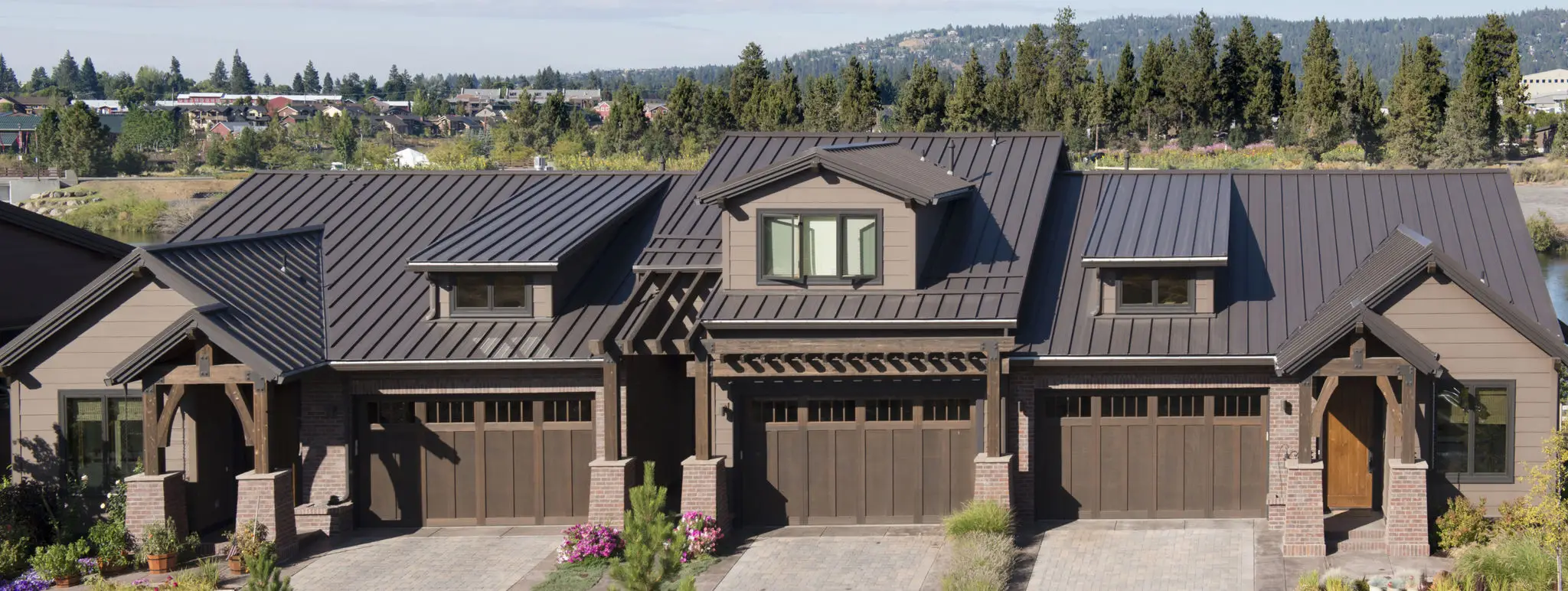Modern house with dark metal roof and garage.