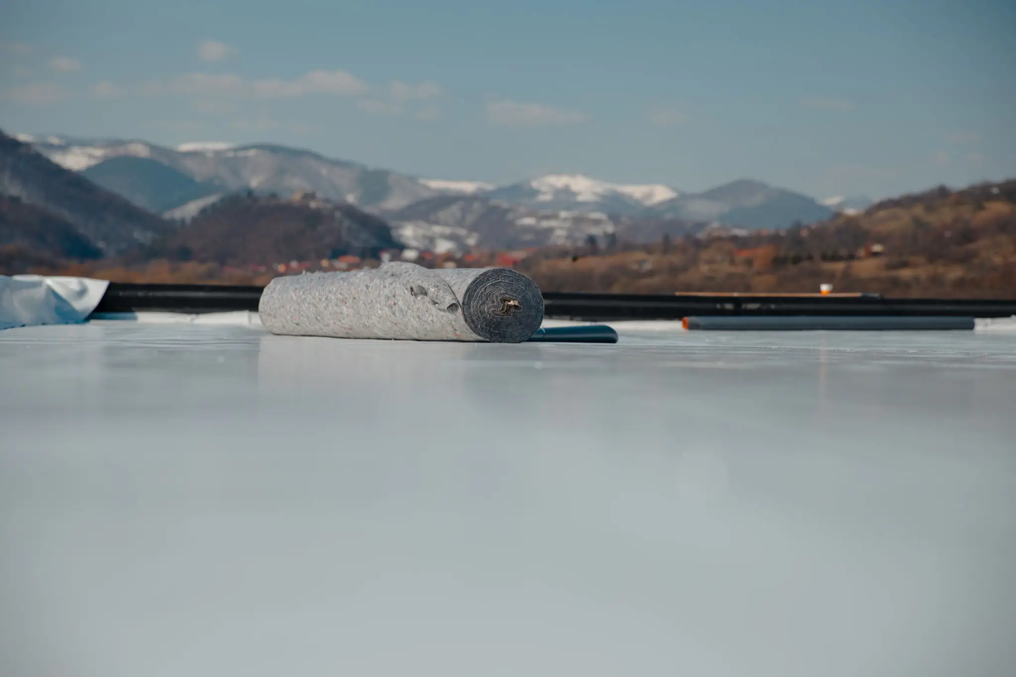 A curling stone sliding on ice during a game.
